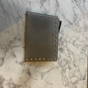 gray Michael Kors wristlet.